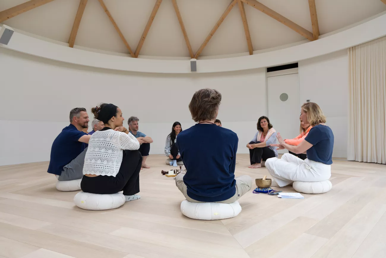 A group of people attend a retreat in the dome.